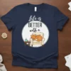 Navy t-shirt with "Life is BETTER with a cat" slogan and illustration of a cat sleeping in an armchair