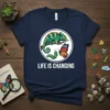 Chameleon, caterpillar, and butterfly graphic with "Life Is Changing" text on a navy blue t-shirt