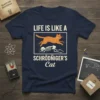 Navy t-shirt with "Life Is Like A Schrödinger's Cat" text and graphic of an orange cat jumping over a skeleton