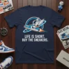 LIFE IS SHORT. BUY THE SNEAKERS. text on a navy t-shirt with a graphic of a winged sneaker with flames