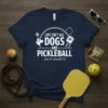 T-shirt with white text "LIFE ISN'T ALL DOGS AND PICKLEBALL ..but it should be" and graphics of a dog and
