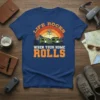Life Rocks When Your Home Rolls text with a retro caravan graphic on a dark blue t-shirt, ideal for RV