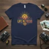 Life In Focus photography quote t-shirt with a sun graphic and camera lens design, suitable for photographers