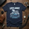 LIFE'S ABOUT GOALS (AND ASSISTS) text with hockey player graphic and net on navy t-shirt