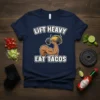 Lift Heavy Eat Tacos t-shirt design featuring a muscular arm lifting a taco with a dumbbell