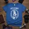 Lift n' Pray He Lifts Me Up Christian fitness t-shirt with praying hands, kettlebell, and thorns graphic
