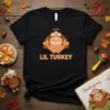 Cute Lil Turkey Thanksgiving graphic t-shirt with cartoon turkey wearing aviator hat and text "LIL TURKEY"