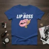 Lip Boss T-Shirt featuring a white crown above bold pink lips biting a golden key
