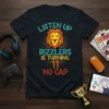 Black t-shirt with "Listen Up Rizzlers is Turning 11 No Cap" text and a stylized lion graphic, celebrating an 11th