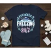 Literally Freezing 24/7 text design with snowy mountains and ice accents on a navy t-shirt
