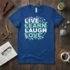 Live Learn Laugh Love quote t-shirt with white and light green lettering surrounded by vines and birds