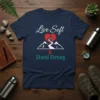 Live Soft & Stand Strong quote t-shirt with a broken heart over mountains graphic