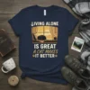 Text reads "Living Alone Is Great A Cat Makes It Better" with a sleeping cat graphic on a navy t-shirt