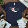 Navy blue t-shirt with "living in the CONE" text and hurricane graphic, featuring a NOAA map and vintage camera