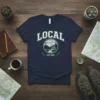 Local Est 2023 t-shirt design featuring the word LOCAL arched above a circular graphic of mountains, trees, and a house
