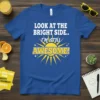 T-shirt with white text "LOOK AT THE BRIGHT SIDE.. I'M STILL AWESOME!" above a yellow sun graphic