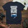Navy t-shirt with "LOOKED GOOD FROM HERE BLUE" text and a framed mountain landscape graphic