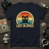 Lost In Space text with a black cat peeking from a retro sunset graphic on a navy t-shirt