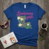 Louisiana Girl t-shirt with a map of Louisiana filled with Mardi Gras beads, magnolia flowers, and a green alligator graphic