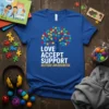 Blue t-shirt with "LOVE ACCEPT SUPPORT AUTISM AWARENESS" text and a tree made of colorful puzzle pieces