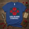 Love Blooms Eternanly quote with red rose graphic on a blue t-shirt