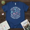 Circle floral design with text "Love Blooms Here Celebrate Identity" on a navy t-shirt, featuring pink and blue flowers