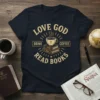 LOVE GOD DRINK COFFEE READ BOOKS text with a coffee cup on books graphic on a navy t-shirt