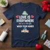 T-shirt with "LOVE IS EVERYWHERE but so is the flu WASH YOUR HANDS" text and graphics of a cartoon germ