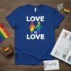 Blue t-shirt with "LOVE IS LOVE" text and two rainbow-clad figures holding hands. Includes Pride flag elements