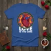 Anatomical heart design with "Love Is The Core" text, surrounded by a crown of thorns, printed on a blue t-shirt