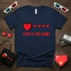 Retro "Love Is The Game" text with pixelated red hearts on a navy blue t-shirt design, inspired by video games