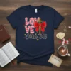 LOVE John 3:16 Christian T-Shirt with a golden cross and red bow, featuring pink and striped lettering