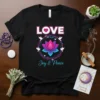 Black t-shirt with "LOVE Joy & Peace" text and a colorful lotus flower with doves graphic, symbolizing peace and spirituality