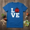 Love Ladybug Design t-shirt with white text and a red ladybug graphic on a blue shirt