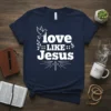 Navy t-shirt with white text "love LIKE Jesus" featuring a dove, olive branches, and a cross graphic