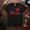 Black t-shirt with red "LOVE & ROCKETS" text, a red rocket launching, and musical notes graphic