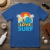 LOVE SURF t-shirt design featuring a surfer riding a wave with palm trees and a sunset graphic