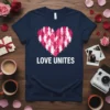 Navy t-shirt with "LOVE UNITES" text and a heart graphic composed of diverse people figures in pink and white