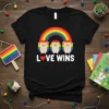 Black t-shirt with "LOVE WINS" text, a red heart icon, and three cute hedgehogs under a rainbow graphic