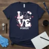 LOVE #CNALIFE text with heart, stethoscope, and nurse hat graphic on a navy blue t-shirt