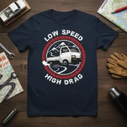 Low Speed High Drag text with a white kei truck graphic on a navy t-shirt, featuring mountains and a winding