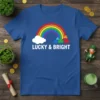Blue t-shirt with white text "LUCKY & BRIGHT" above a rainbow, cloud, and shamrocks, designed for St. Patrick's Day