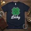 Navy t-shirt with white text "Lucky" and a green four-leaf clover graphic with a white outline