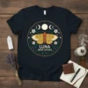 Luna Moon Goddess t-shirt design with a yellow moth, moon phases, and floral accents