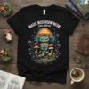 Black t-shirt featuring "Magic Mushroom Meow Fungal Familiars" text above a cute cat under a mushroom cap with surrounding mushrooms