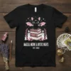 Magical Meows & Mystic Nights Est. 2023 t-shirt design featuring a black bat-winged cat on books with candles