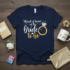 Maid of honor of the bride to be text with diamond ring graphic on a navy t-shirt