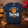 Navy blue t-shirt with "MAKE HALLOWEEN GREAT AGAIN TRUPKIN 2020" text and a pumpkin-headed Donald Trump illustration