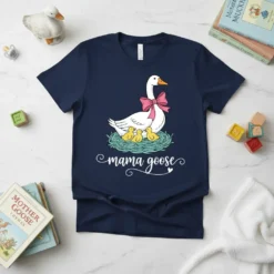 Mama Goose T-Shirt design with a white goose wearing a pink bow and three yellow ducklings in a nest
