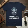 Geometric cat design with "Many Eyes, One Vision" text, featuring multiple blue eyes on a navy t-shirt